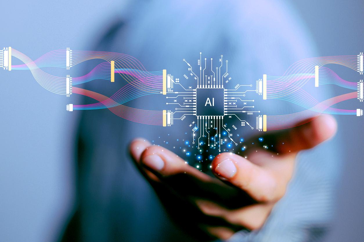 Eine Hand ist nach vorn ausgestreckt, darüber ist eine virtuelle Grafik mit "AI" in der Mitte zu sehen