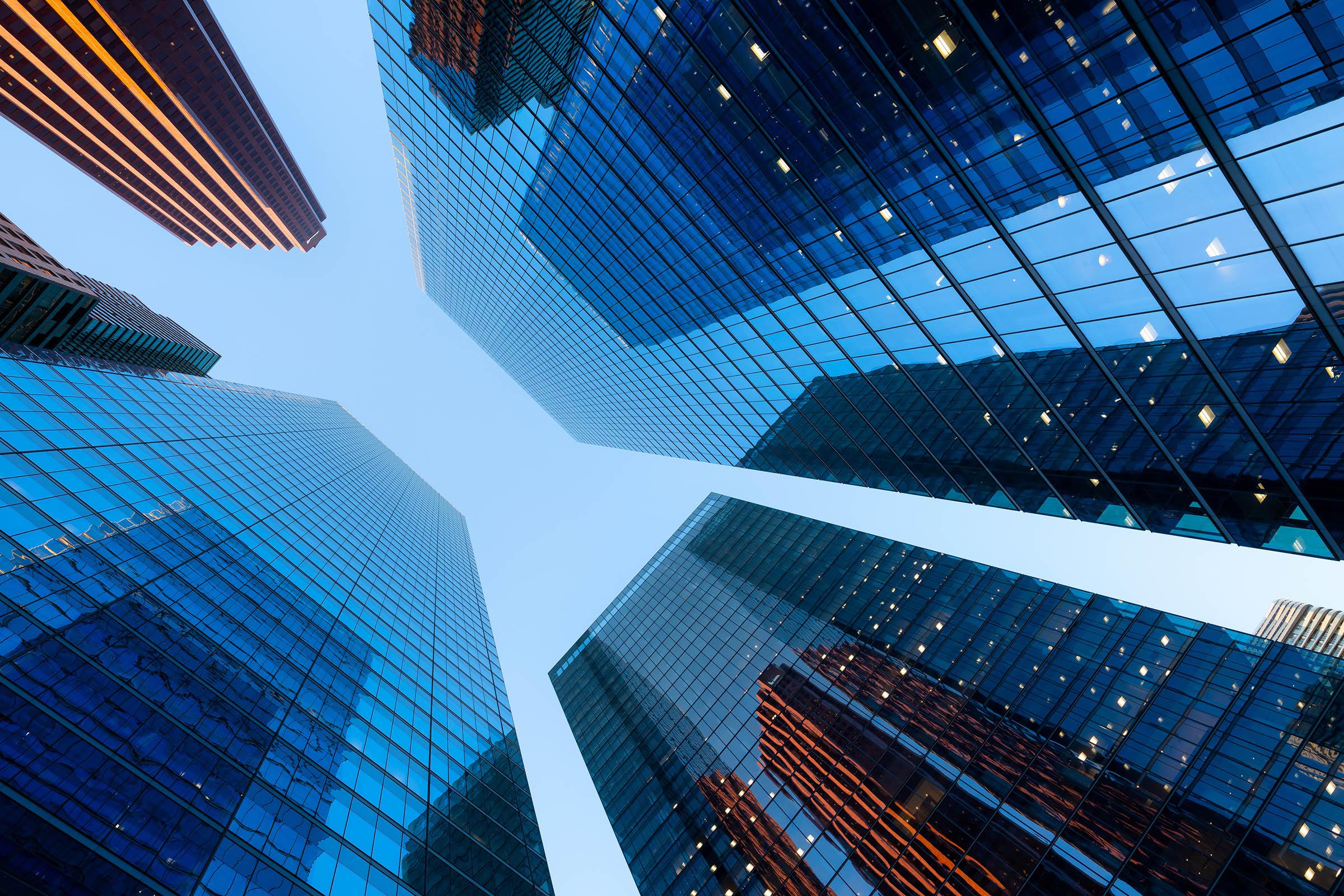 View of the sky through the rows of buildings of several skyscrapers